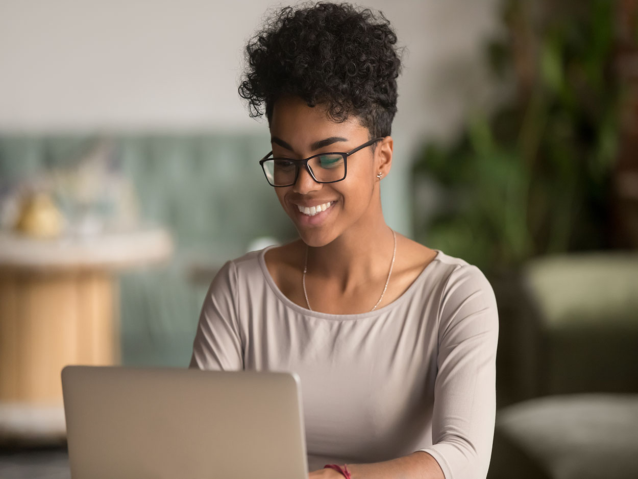 Smiling woman typing at computer